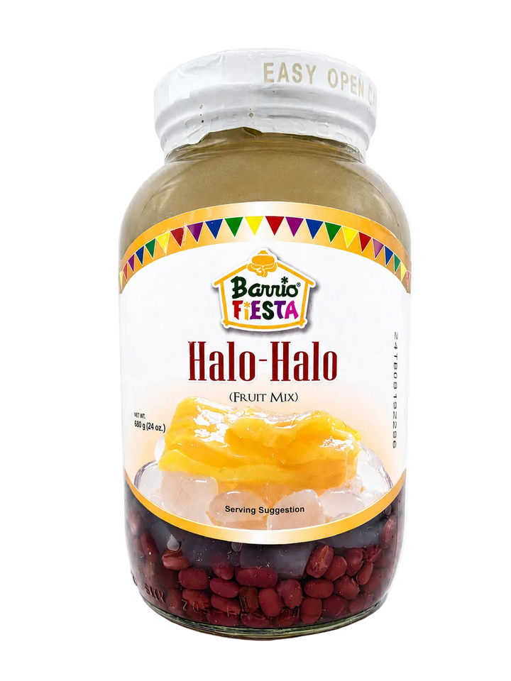 A glass jar of Barrio Fiesta Halo-Halo fruit mix, featuring a white label with a colorful Mexican flag pattern, showing yellow mango and red beans at the bottom, on a white background.