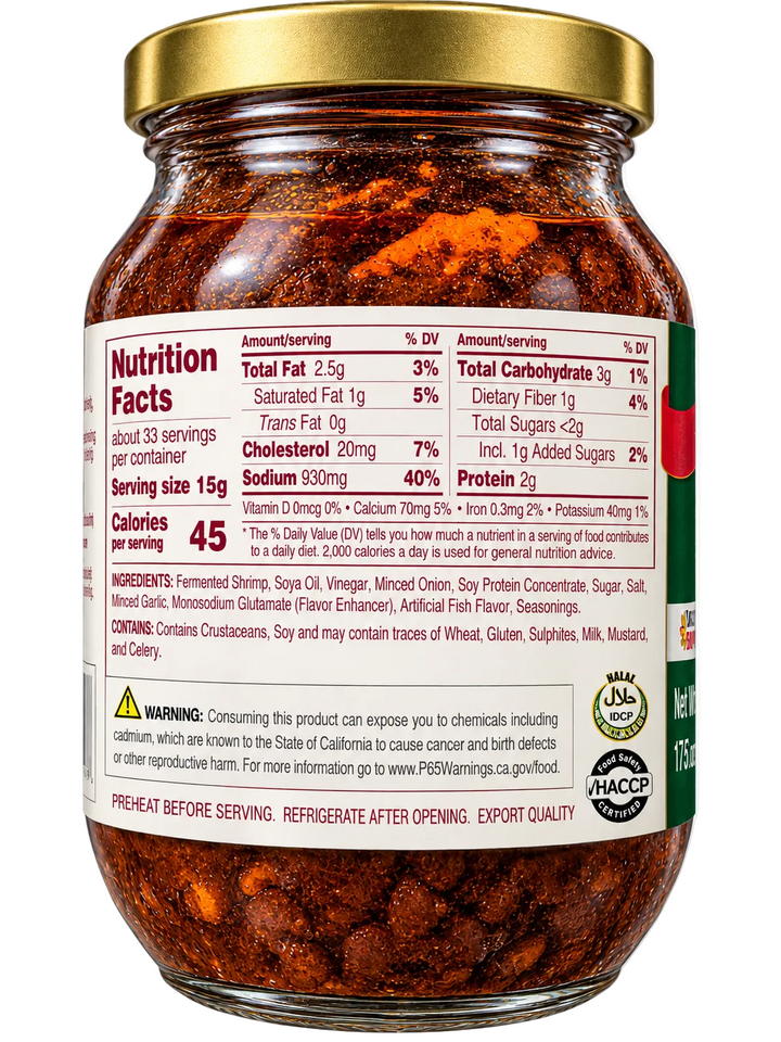 Back label of Kamayan Ginisang Bagoong Regular Sauteed Shrimp Paste glass jar with gold lid, displaying nutrition facts, ingredients, allergen information, California Proposition 65 warning, Halal and HACCP certifications, and storage instructions.