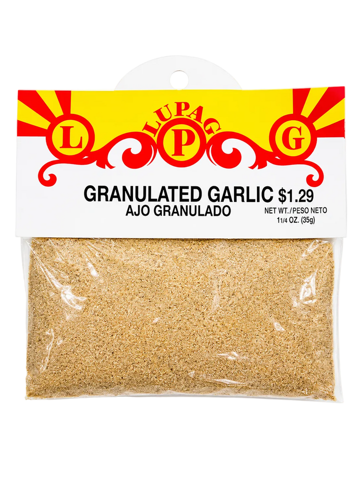 A 1 1/4 oz package of Lupac Granulated Garlic (Ajo Granulado) showing the clear plastic bag filled with light brown granules and a white and yellow header card with red branding.