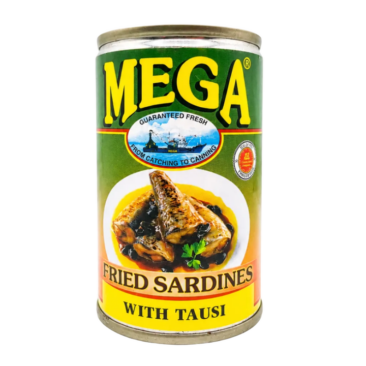 Front view of a Mega Fried Sardines with Tausi can, 155g (5.5 oz.), displayed upright on a bright white background. The label features the MEGA logo in bold yellow letters on a green background, the product name "Fried Sardines with Tausi," an appetizing serving suggestion of fried sardines in black bean sauce with garlic and herbs, and the "No Preservatives" badge. The can is centered, brightly lit, straightened, and photographed in a clean studio setting for an e-commerce product listing.
