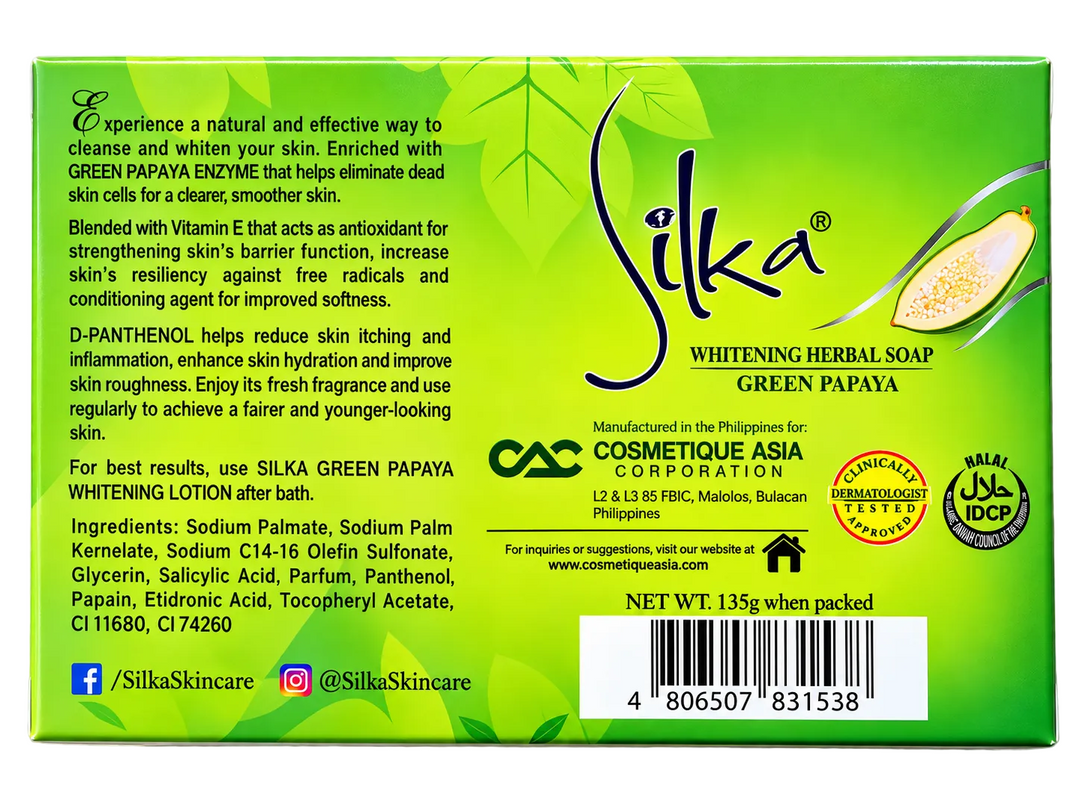 Back view of Silka Green Papaya Whitening Herbal Soap 135g in green packaging, showing green papaya enzyme, Vitamin E and D-Panthenol benefits, product ingredients, manufacturer information, dermatologist-tested and Halal certification seals, and barcode.