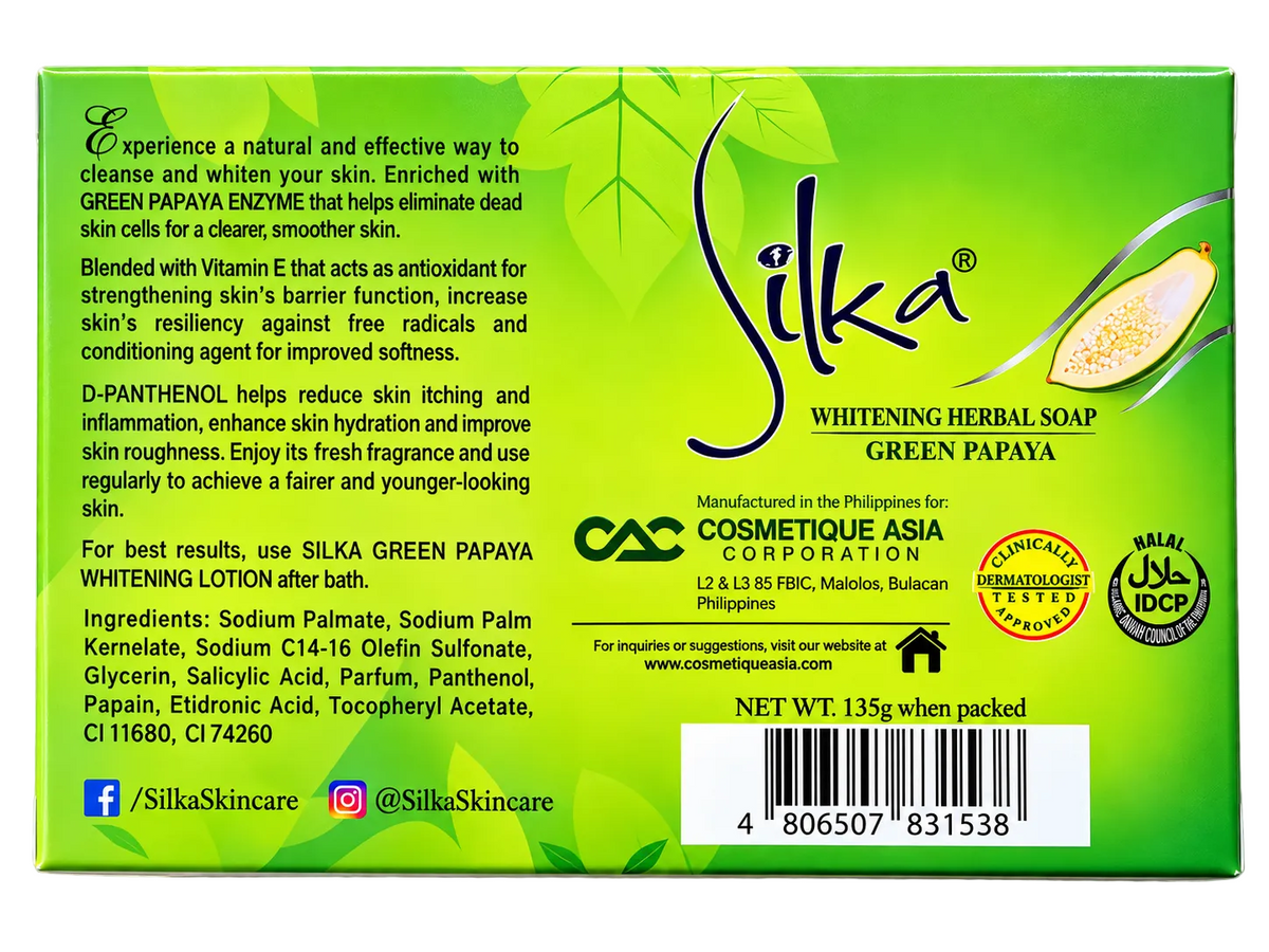 Back view of Silka Green Papaya Whitening Herbal Soap 135g in green packaging, showing green papaya enzyme, Vitamin E and D-Panthenol benefits, product ingredients, manufacturer information, dermatologist-tested and Halal certification seals, and barcode.