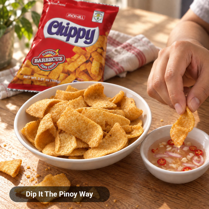 Jack 'n Jill Chippy BBQ Corn Chips in a bowl, hand dipping a chip into spiced vinegar with chili and onion, Dip It The Pinoy Way