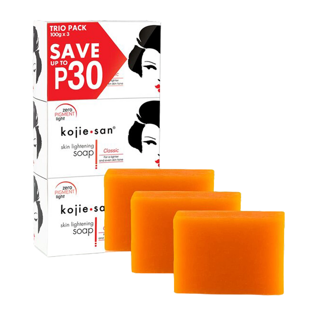 Three orange rectangular bars of kojie san skin lightening soap arranged in front of their white and red retail packaging box on a plain white background.
