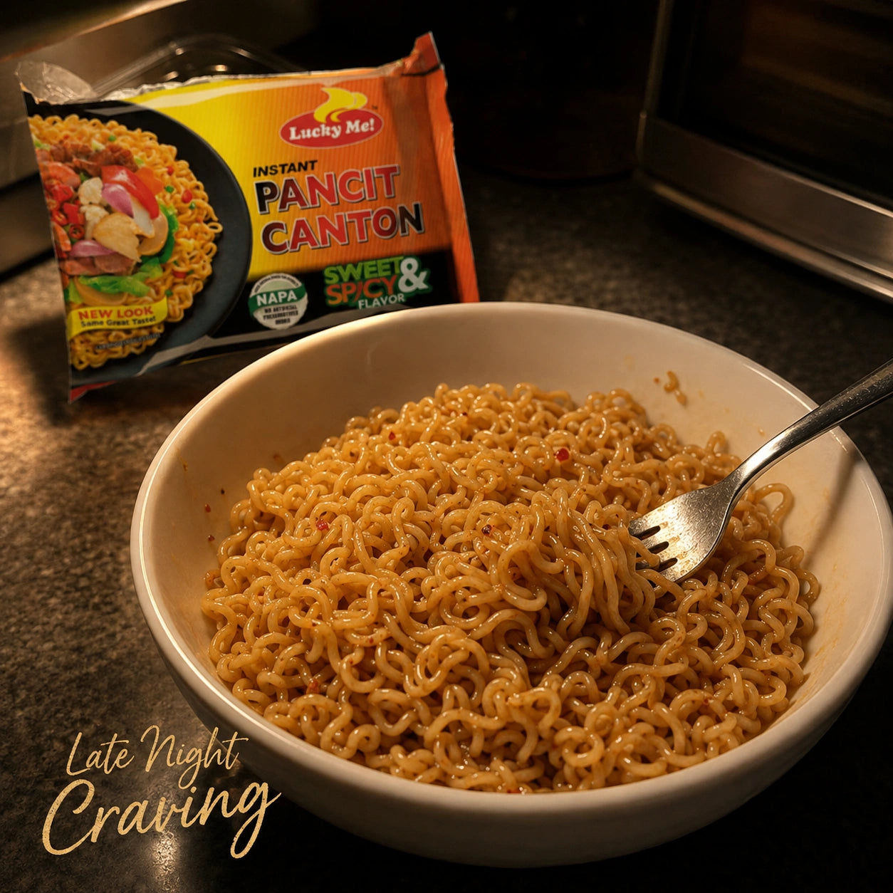 Bowl of cooked Lucky Me Pancit Canton Sweet & Spicy instant noodles with a fork, package shown beside it, Late Night Craving