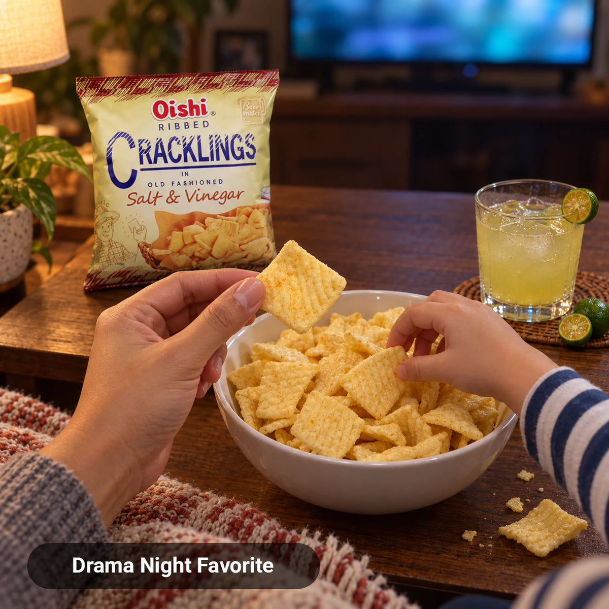 Filipino parent and child sharing Oishi Ribbed Cracklings Salt & Vinegar snack during family drama night