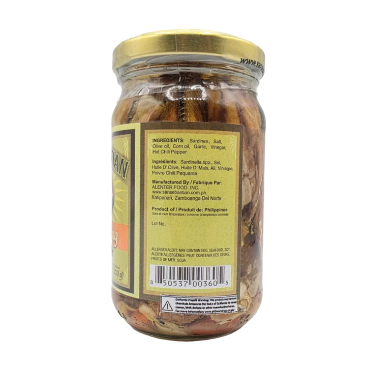 Jar of pickled vegetables with a gold lid on a white background