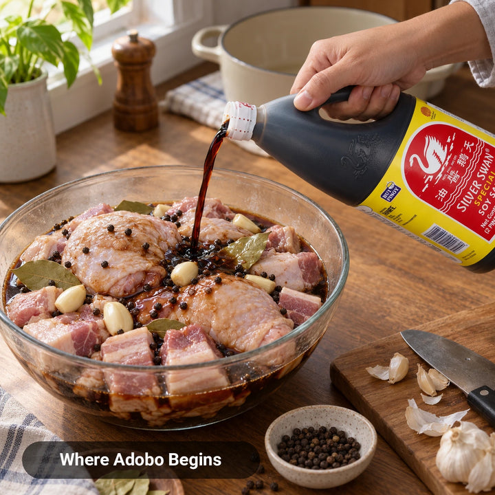 Silver Swan Special Soy Sauce poured over chicken and pork adobo marinade with garlic and bay leaves, Where Adobo Begins